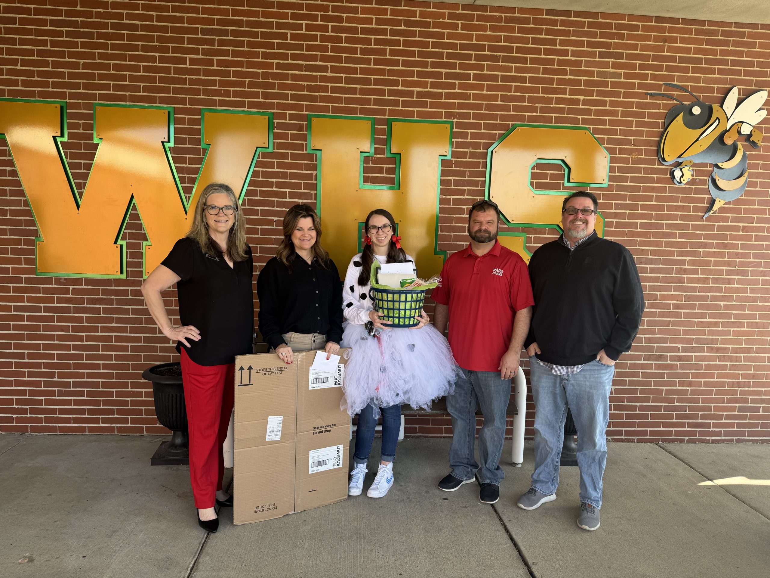 Teacher of the Month is presented her prizes from the team of community leaders